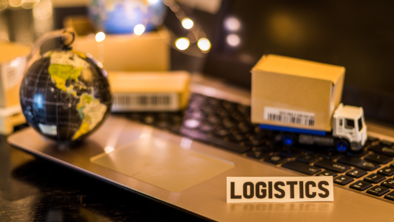 Image of Logistics name board on desk along with a globe showpiece.